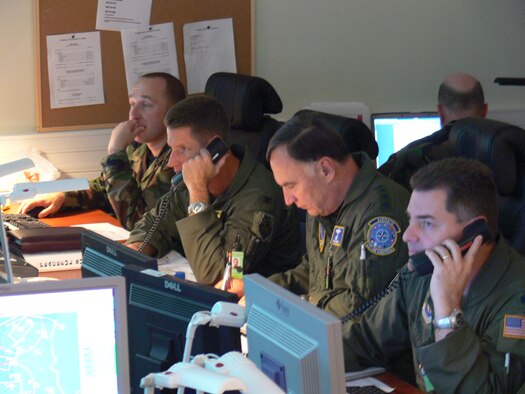 Gen. Tom Hobbins, USAFE commander and commander, NATO Air Component Command Ramstein (center right) leads the Combined Joint Air Operations Center team monitoring the skies over the Baltics during NATO’s Riga Summit in Latvia Nov. 28 & 29. Others in the photo include, from left, Maj. B.J. Cottrell, legal advisor, Col. Pete Castor, 322 Air Expeditionary Group commander, Gen. Hobbins, and Lt. Col. David Jorgensen, NATO/US Watch Advisor.  Personnel from thoughout USAFE provided fighter, tanker, maintenance and communications support in seven countries, as well as staffing the Combined Joint Air Operations Center in Riga.  (Photo by Maj. Lisa Neidinger, 3rd Air Force Public Affairs)
