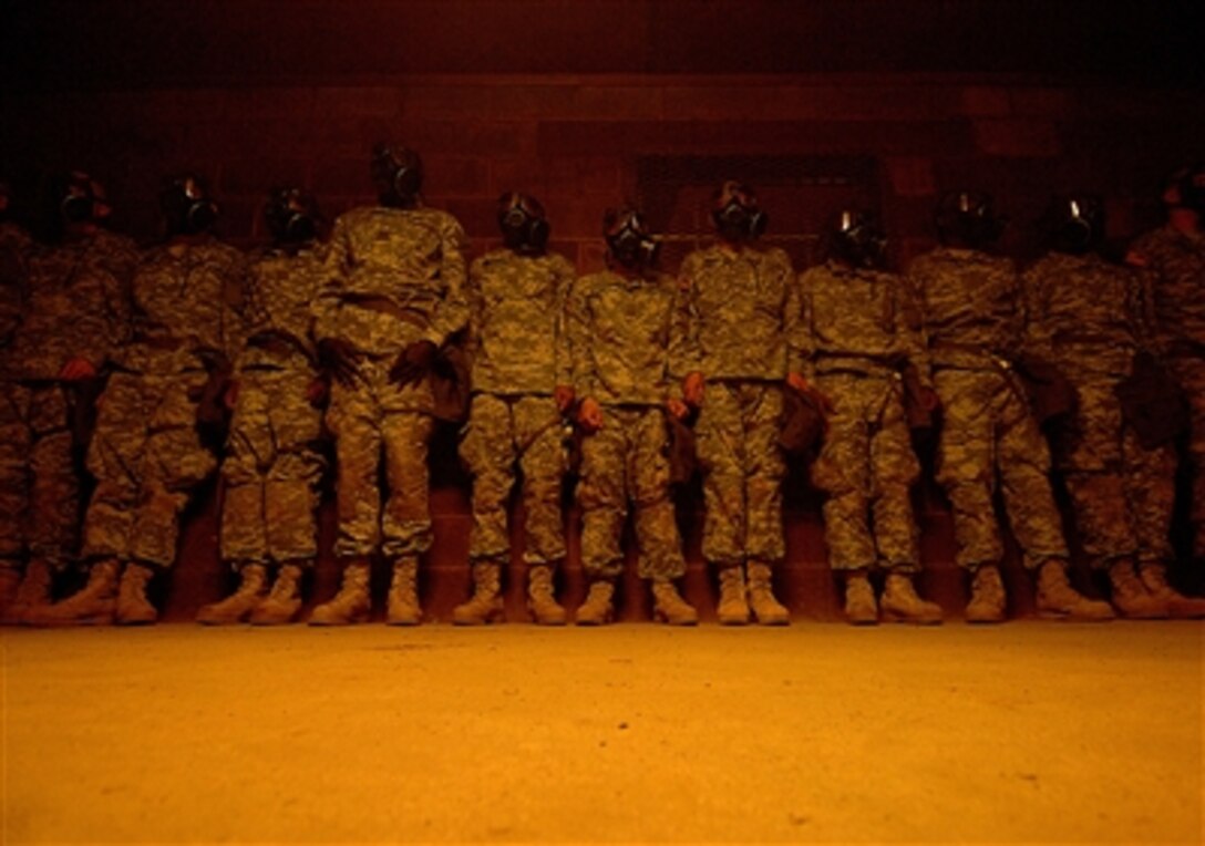 Soldiers line the wall of the gas chamber Dec. 5, 2006, while going through U.S. Army basic combat training at Fort Jackson, S.C.  