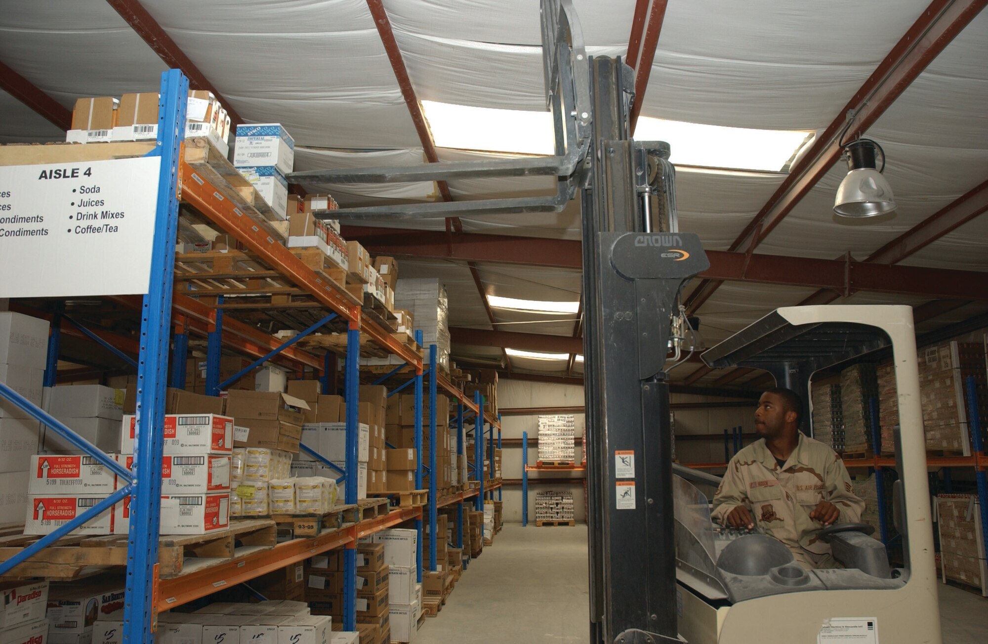 SOUTHWEST ASIA --  While at Al Udeid Air Base, Staff Sgt. Samuel Hudson, from the 325th Services Squadron, organizes a food stock room. (Courtesy photo)
