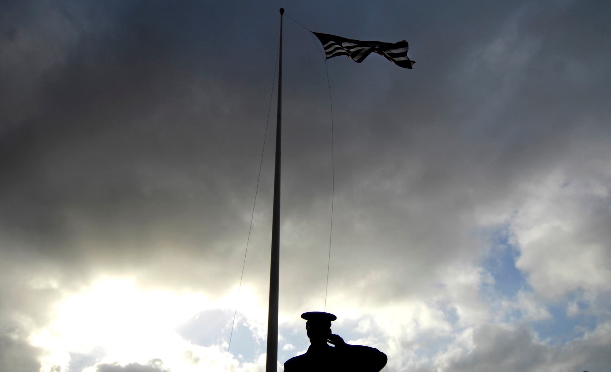 A ceremony at the Hickam Air Force Base, Hawaii, flagpole was held Dec. 7 to honor the 189 who died and 303 who were wounded during a surprise attack by Japanese fighter aircraft 65 years ago.  The consolidated barracks, what is now the Pacific Air Forces headquarters, was reportedly the most bombed building on Oahu. (U.S. Air Force photo/Tech. Sgt. Shane A. Cuomo) 