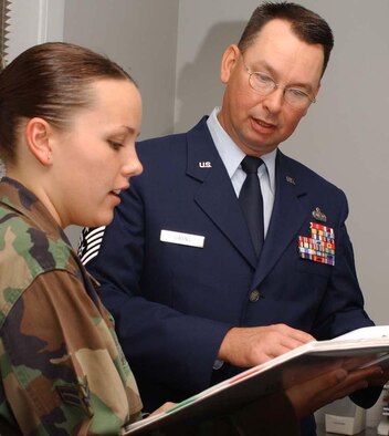 Airman 1st Class Sara Johnson, left, 81st Training Wing administrative staff, goes over inprocessing paperwork with Chief Master Sgt. Ronald Owens, the wing’s new command chief. He replaces Chief Master Sgt. Aliquippa Allen, who retired. He comes to Keesler from Charleston Air Force Base, S.C., where he was the 437th Mission Support Group’s superintendent. He’s served in squadron to major command positions and was deployed to Iraq as chief enlisted manager of the 447th Air Expeditionary Group at Baghdad International Airport. (U.S. Air Force photo by Kemberly Groue)