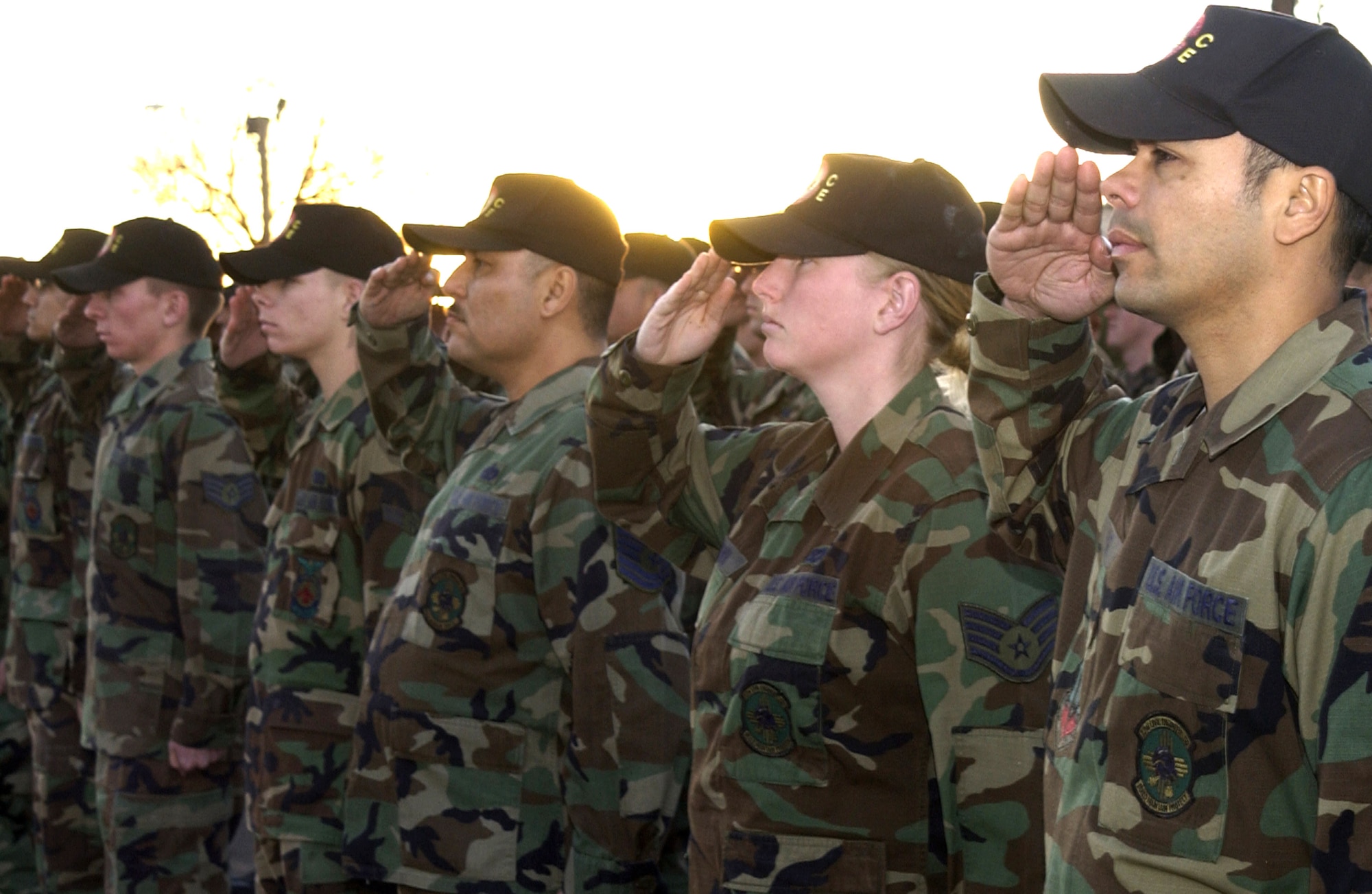 Members of the 27th Civil Engineer Squadron salute the flag during a special retreat ceremony Dec. 6 in remembrance Capt. Kermit Evans, the 27th CES Explosive Ordnance Flight commander at Cannon Air Force Base, N.M. Captain Evans was killed Dec. 3 as a result of a U.S. Marine helicopter emergency water landing near the shore of Lake Qadisiyah in Al Anbar Province, Iraq. (U.S. Air Force photo/Senior Airmam Heather R. Redman)