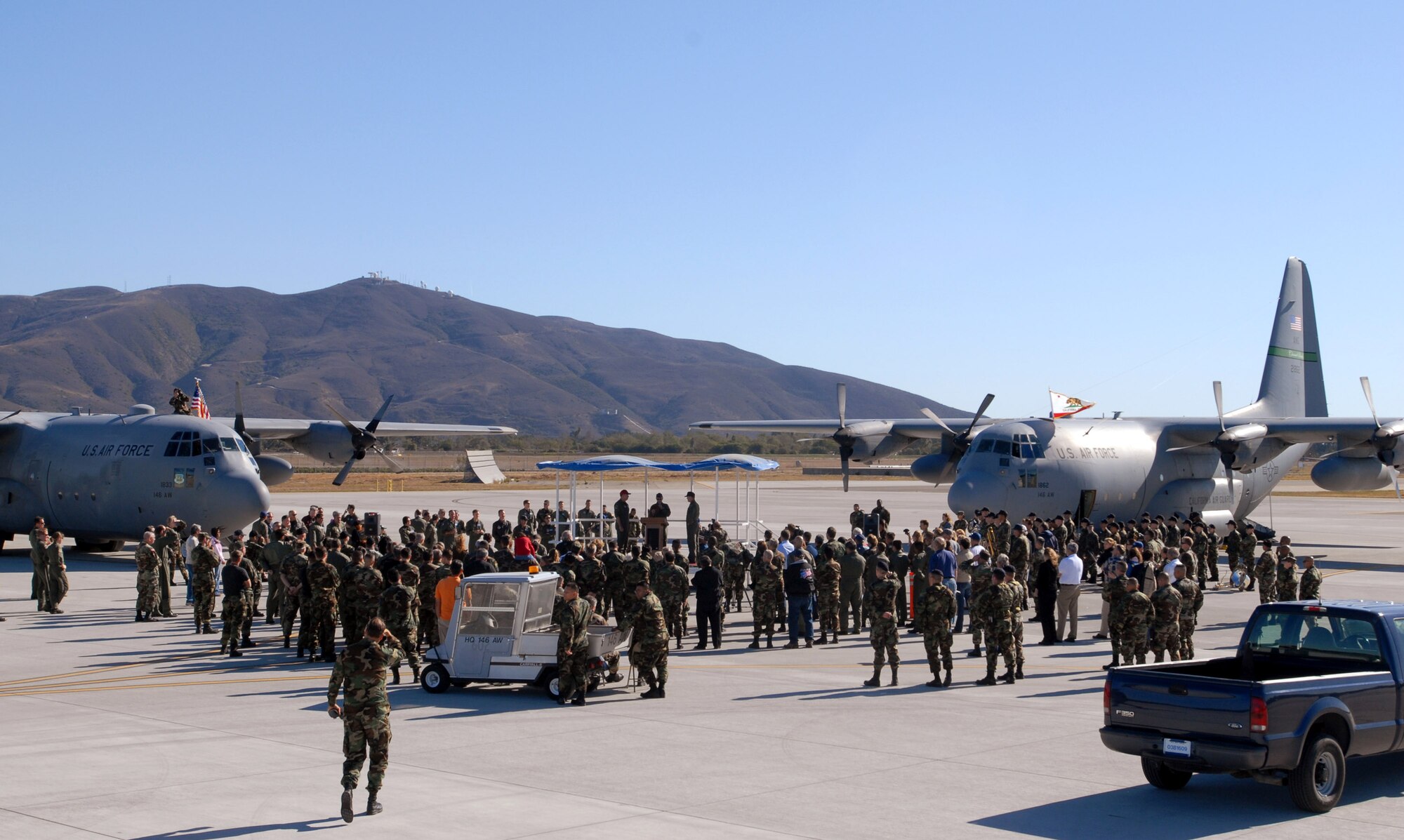 Memeber of the 146th Airlift Wing prepare to send off aircraft 1862 and 1833 Dec. 2 from Channel Island Air National Guard Station, Calif. Wing Airmen flew their last two C-130 Hercules for the final time. The aircraft were delivered to the Air Force in the early 1960's and came to the 146th in 1974. They served in many ways including bringing in relief supplies and tranporting injured citizens natural disasters, most recently Huricane Katrina. The wing's C-130s were also capable of delivering fire retardant to help fight wildfires. (U.S. Air Force photo/Tech. Sgt. Dave Buttner) 