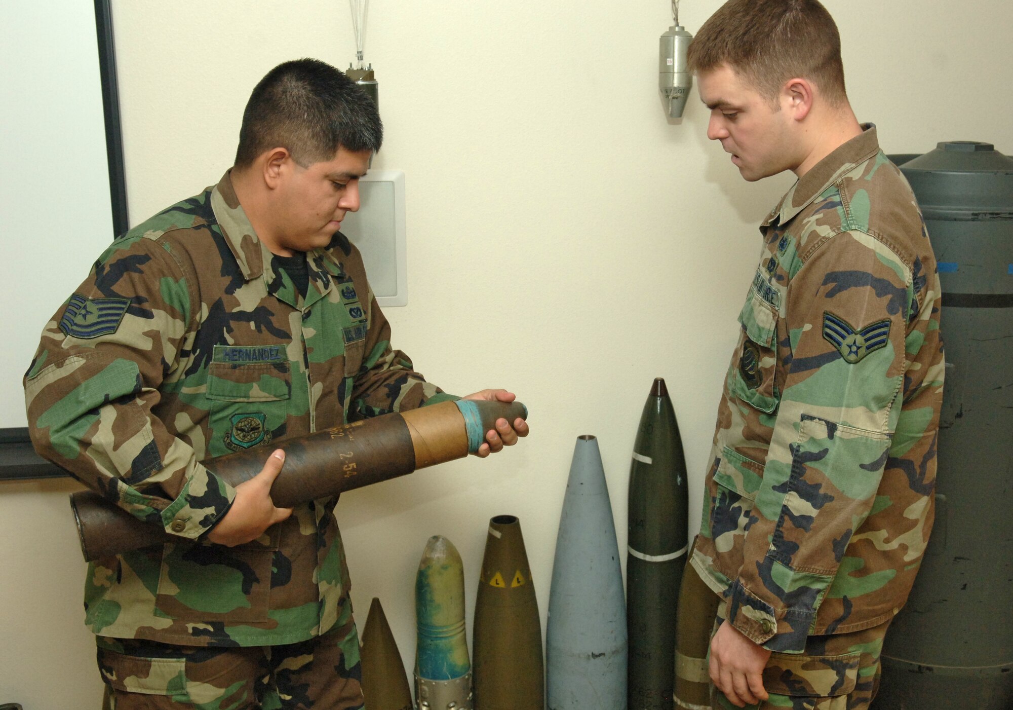 FAIRCHILD AIR FORCE BASE, Wash. -- Tech. Sgt. Jesus Hernandez and Senior Airman Amos Smith of the 92nd Civil Engineer Squadron Explosive Ordinance Disposal team show off a 3.5 inch Korean War era practice bazooka rocket Tuesday. Sergeant Hernandez received a Bronze star and Airman Smith received an Army Commendation Medal with valor device. (U.S. Air Force photo/Senior Airman Jessica Fuentez)