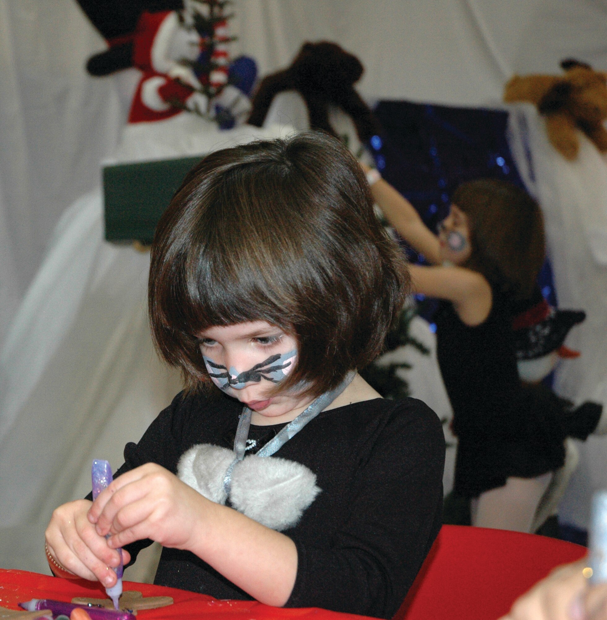 TYNDALL AIR FORCE BASE, Fla. --  Emily Douglas makes a Christmas ornament at the Youth Center Saturday during the annual Breakfast with Santa. Military families enjoyed pancakes and children had the opportunity to make Christmas crafts. (U.S. Air Force photo by Chrissy Cuttita)