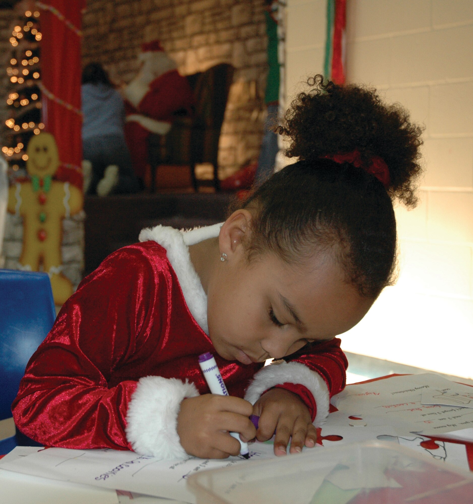 TYNDALL AIR FORCE BASE, Fla. --  Mikaelah Grant writes a letter to Santa at the Youth Center during the annual Breakfast with Santa. Military families enjoyed pancakes and children had the opportunity to make Christmas crafts. (U.S. Air Force photo by Chrissy Cuttita)