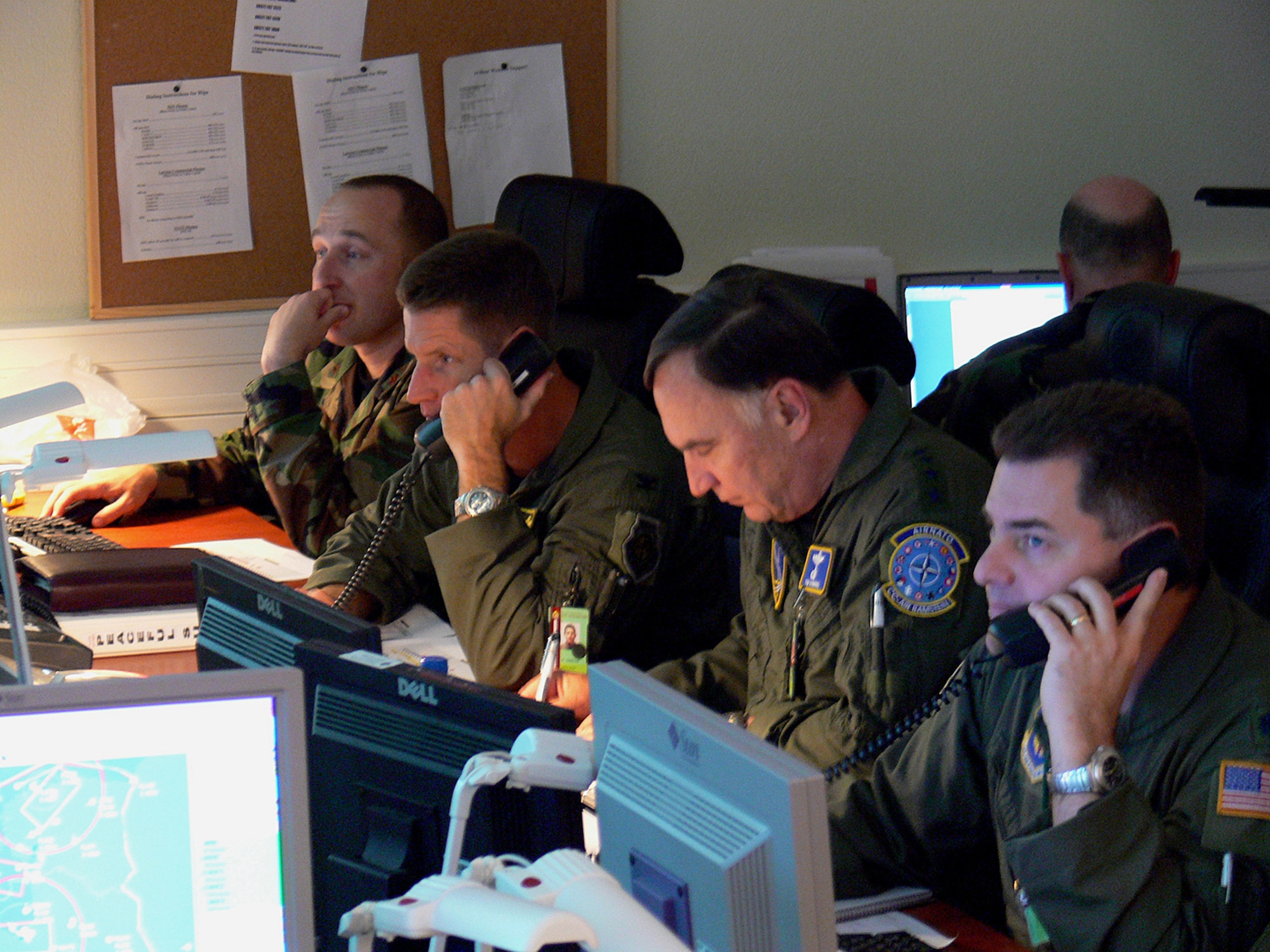 Gen. William T. Hobbins (center right) leads the Combined Joint Air Operations Center team monitoring the skies over the Baltics during NATO's Riga Summit in Latvia Nov. 28 and 29. General Hobbins is the U.S. Air Forces in Europe commander and commander, NATO Air Component Command Ramstein. Others in the photo include, from left, Maj. B.J. Cottrell, legal advisor, Col. Pete Castor, 322 Air Expeditionary Group commander, and Lt. Col. David Jorgensen, NATO/U.S. watch advisor. Members from thoughout USAFE provided fighter, tanker, maintenance and communications support in seven countries, as well as staffing the Combined Joint Air Operations Center in Riga. (U.S. Air Force photo/by Maj. Lisa Neidinger)