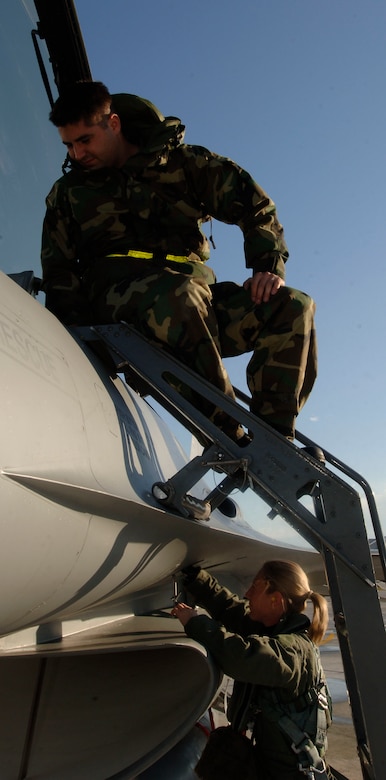 Captain Katherine Gaetke, F-16 pilot from the 523 Fighter Squadron, and Crew Chief Staff Sergeant Michael Brooks from the 524 Aircraft Maintenance Unit  prepare to fly dissimilar aircraft training at Langley Air Force Base, Virginia, December 4, 2006.  (US Air Force photo by Airman First Class Christopher L. Ingersoll)