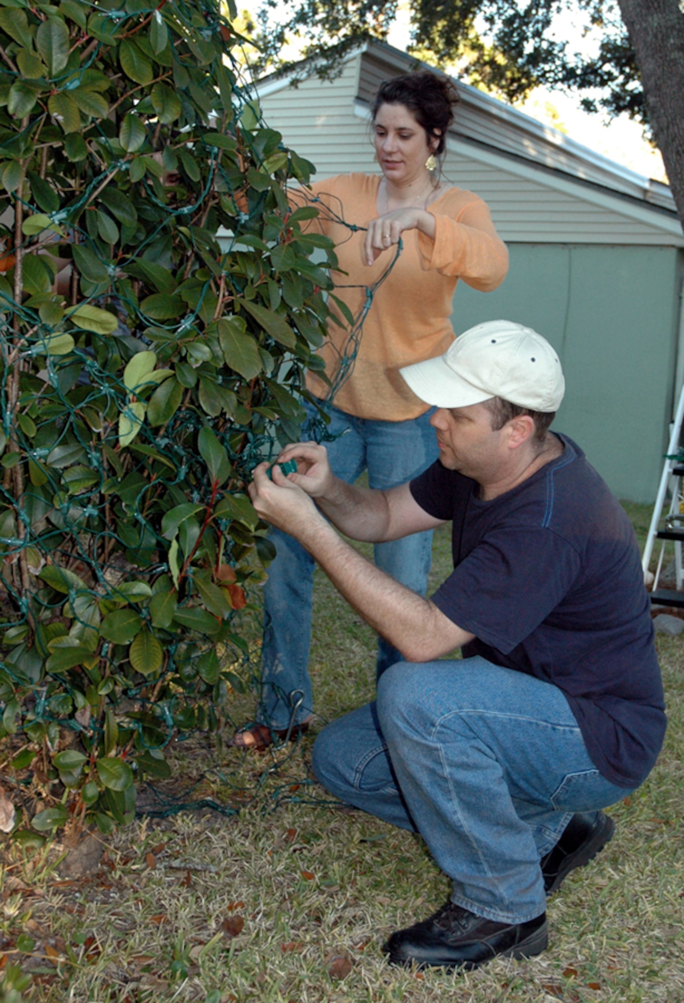 Tech. Sgt. Daniel Hunt, 1st Special Operations Aircraft Maintenance Squadron, and his wife, Hannah, decorate their base residence Nov. 25. The warm November weather was a treat for the family who moved here from Alaska. (U.S. Air Force Photograph by Master Sgt. Stuart Camp)