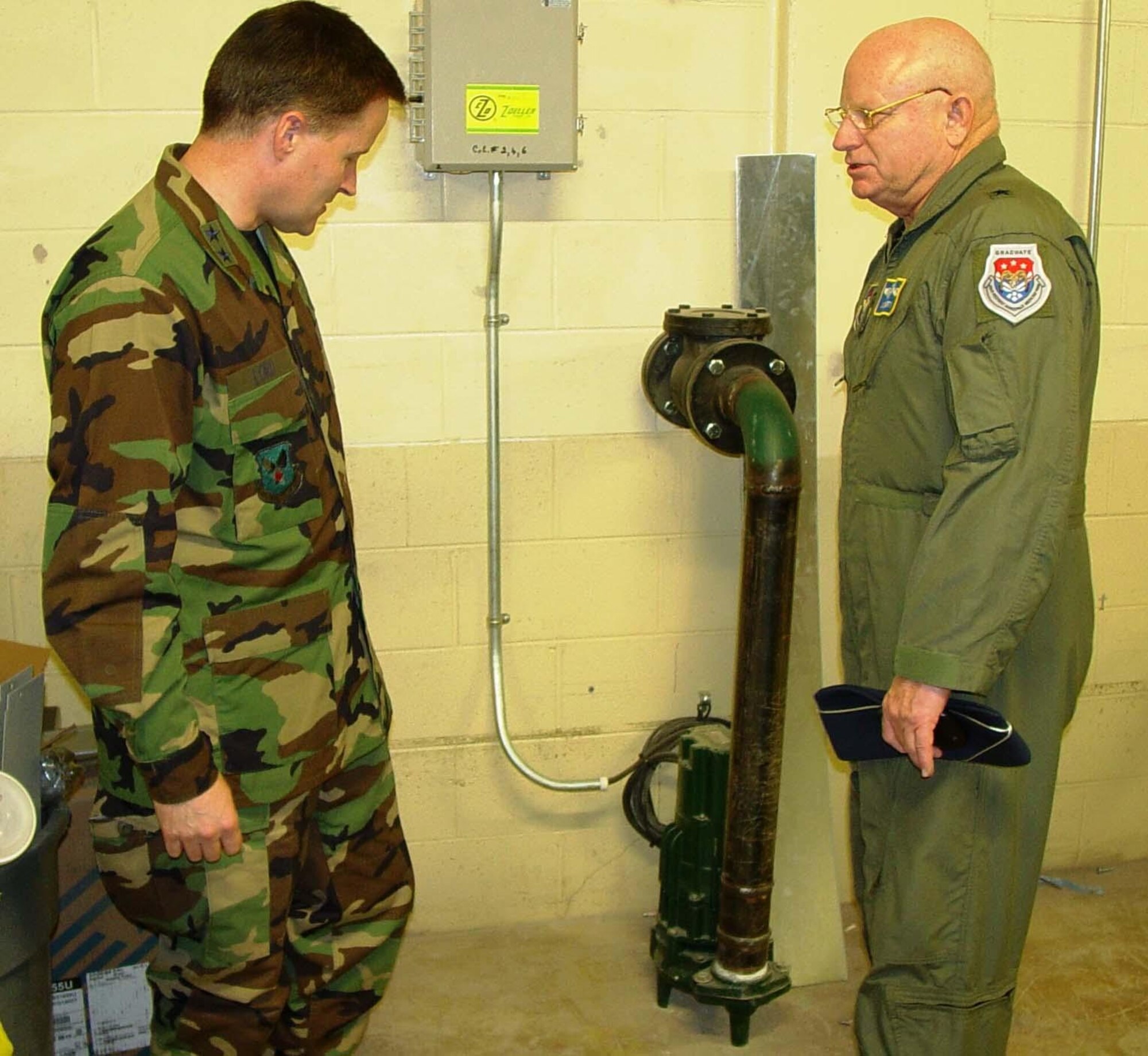 General Lord, left, is shown a sump pump installed in Keesler Medical Center’s generator room by Brig. Gen. (Dr.) James Dougherty, 81st Medical Group commander. General Lord was the 81st Training Wing commander when Hurricane Katrina struck Keesler Aug. 29, 2005. Several sump pumps have been installed in critical areas of the medical center basement as part of flood mitigation efforts to prevent a recurrence of damage similar to what Katrina inflicted on the facility. (U.S. Air Force photo by Steve Pivnick)