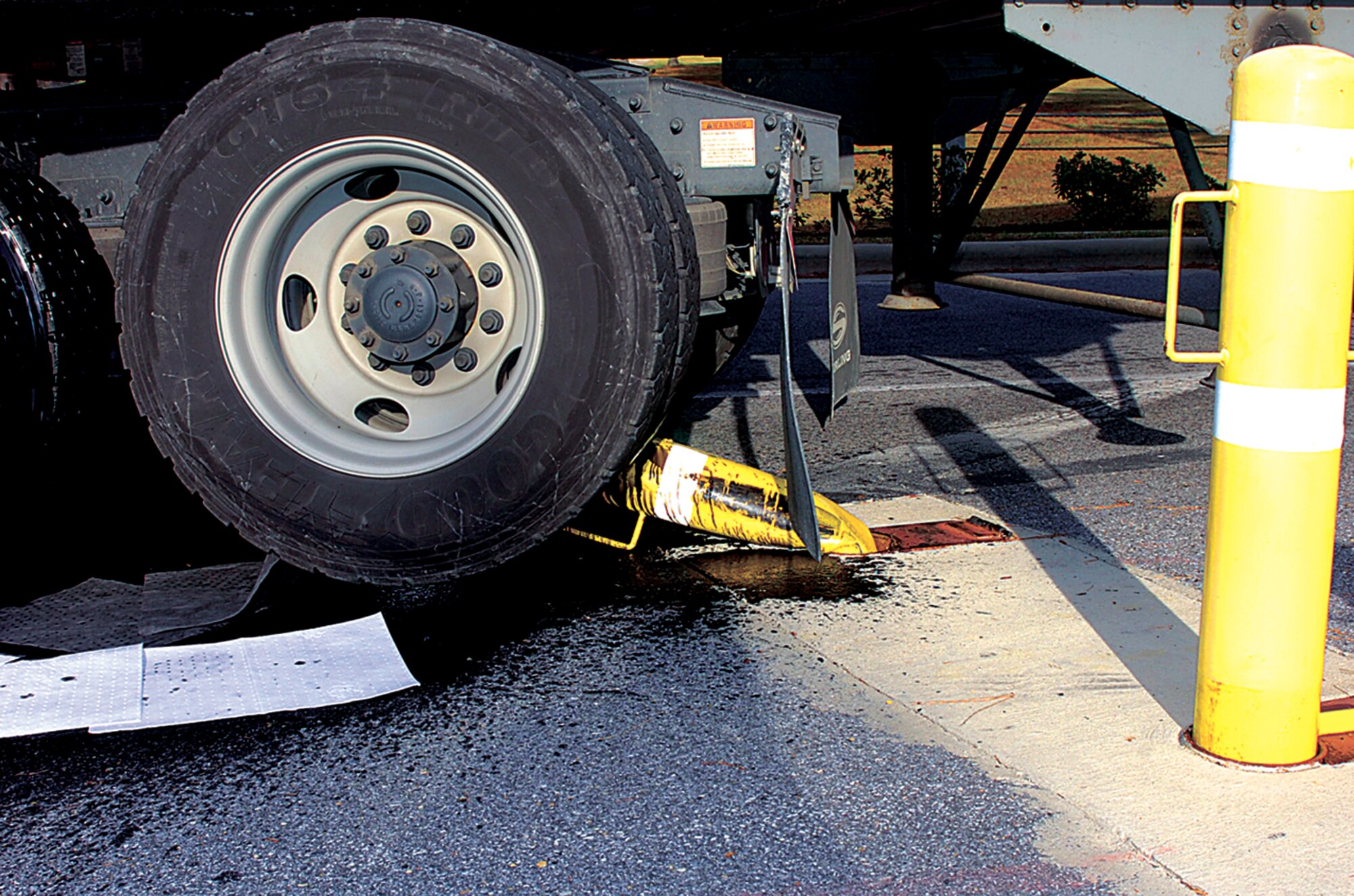 SEYMOUR JOHNSON AIR FORCE BASE, N.C. - At the Slocumb Gate, a tractor trailor barrels over a security bollard, which destroyed the vehicle?s undercarriage. (U.S. Air Force photo by Airman 1st Class Greg Biondo)