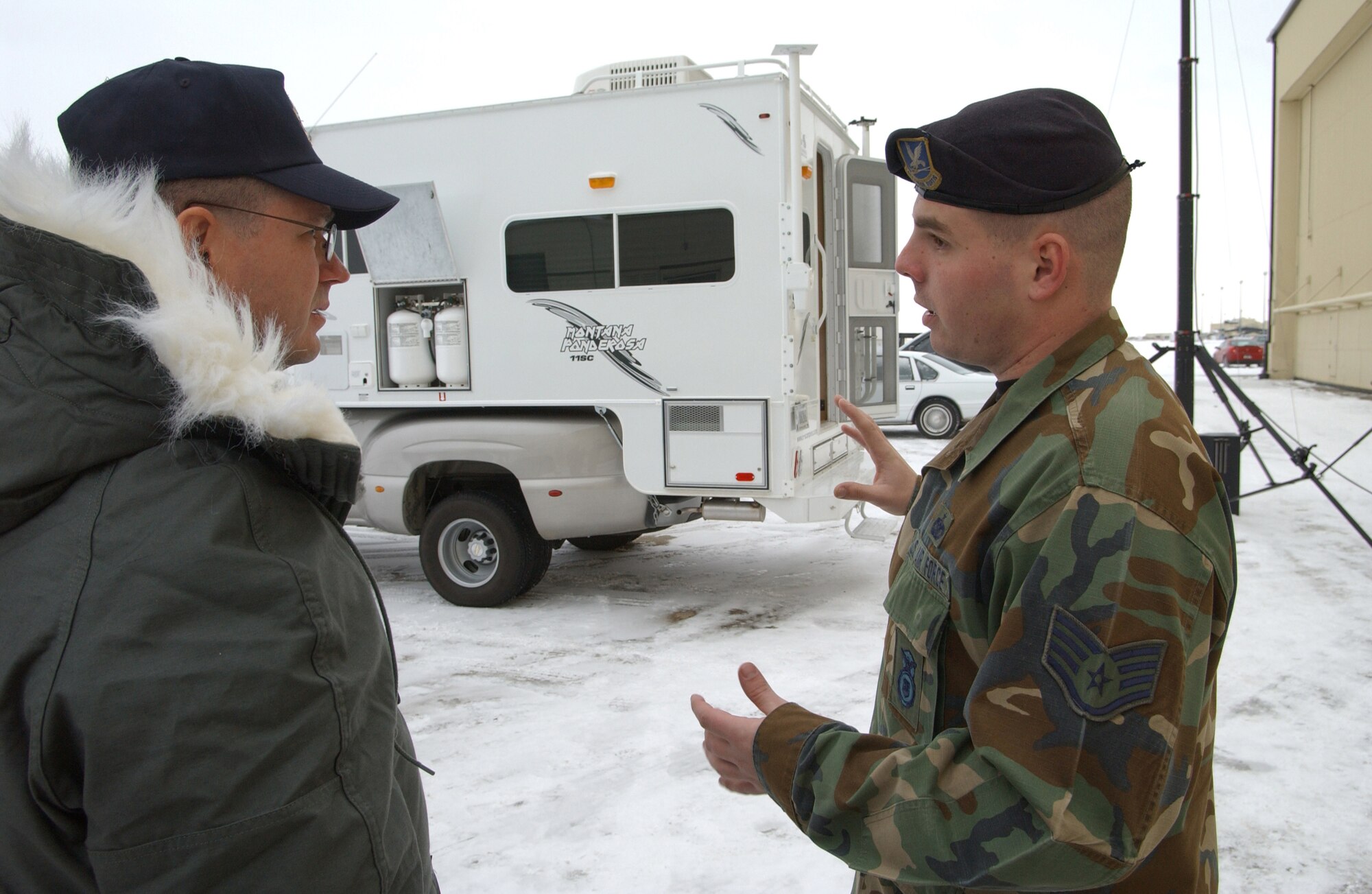 Staff Sgt.  William Blado, NCOIC of the camper alert security teams, talks to Chief Master Sgt. Michael Sullivan, Air Force Space Command command chief,  about the capabilities and improvements of the new Security Forces campers being deployed by the 341st Security Forces Group. 