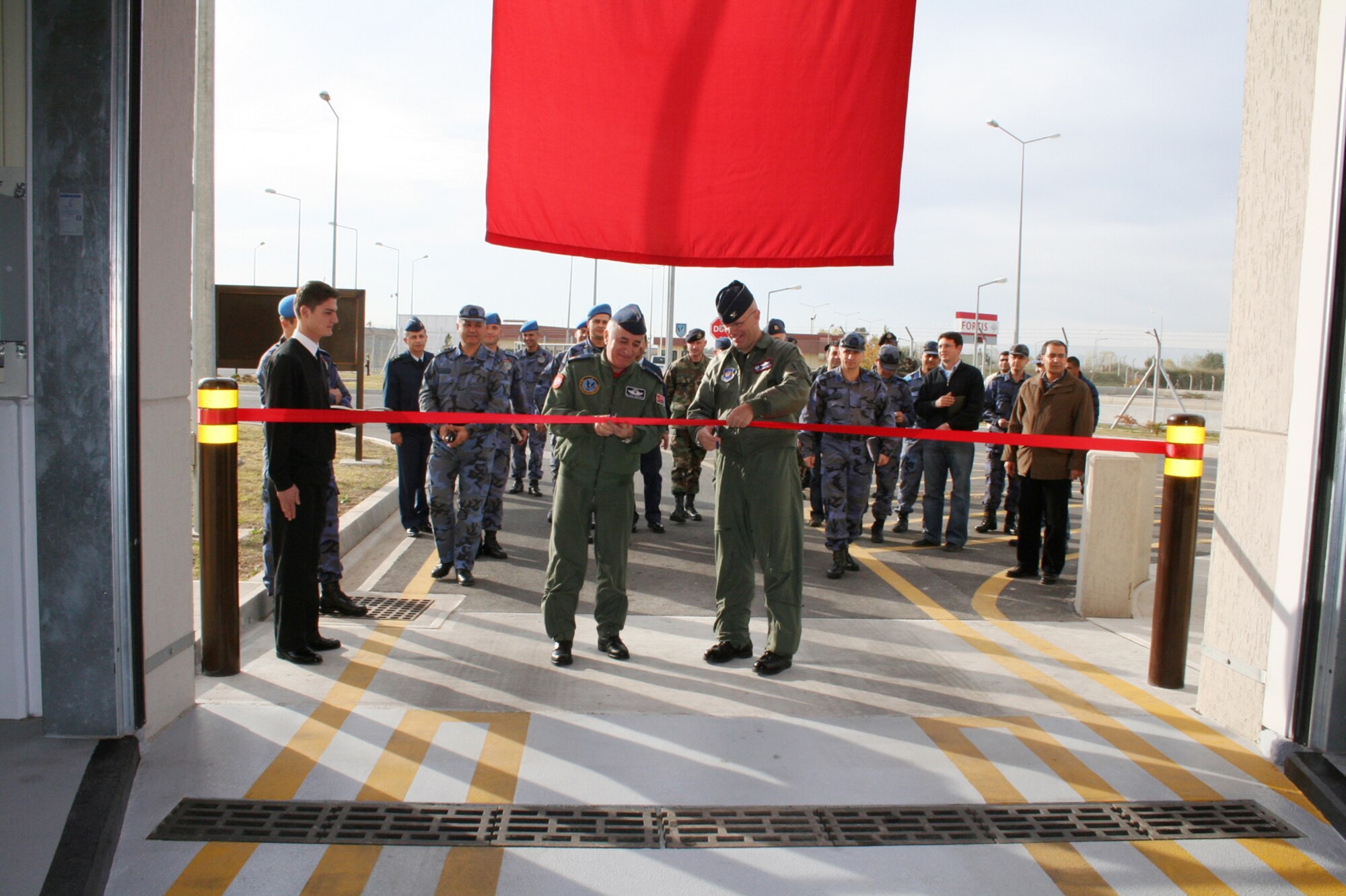 Col. Murrell "Tip" Stinnette, 39th Air Base Wing commander, right, and Brig. Gen. M. Yilmaz Erdogan, left, 10th Tanker Command commander, cut the ribbon at the large vehicle inspection station here Dec. 5. The buiding is a joint effort between the 10th Tanker Command and the 39th Air Base Wing. (Courtesy of 10th Tanker Command)