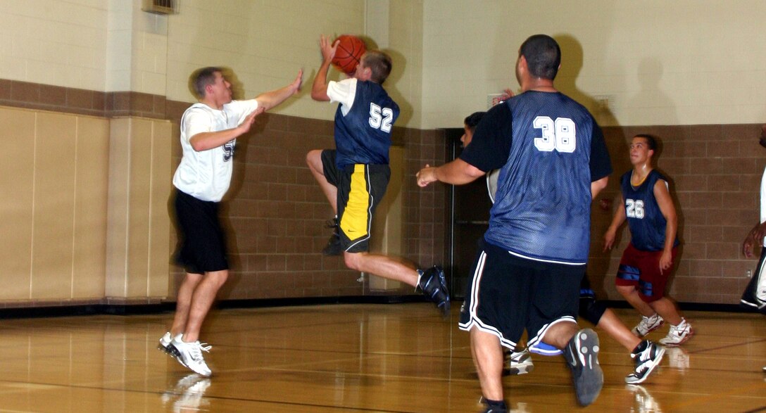 Charles Osbourne, from the 82nd Communications Squadron intramural basketball team, jumps while attempting a lay-up in the 82nd CS’s game agaist the 82nd Security Forces Squadron Cops Tuesday night. (U.S. Air Force photo/Airman Jacob Corbin.)