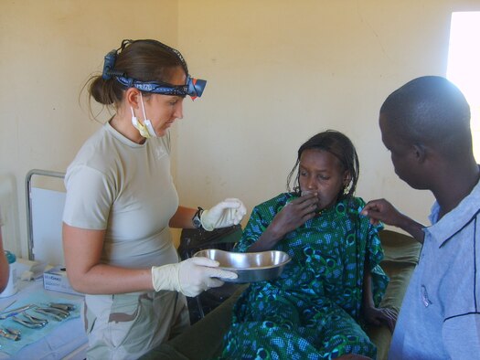 Capt. Sarah Clark, a dentist with the 435th Medical Group, checks the teeth of a Malian child during a Medical Capability program conducted near Gao, Mali. Capt. Clark and other military medical and dental professionals deployed with Special Operations Forces as part of the latest in a series of Joint Combined Exchange Training events. The training, aimed at fostering communication and cultural exchanges between the two militaries, is part of the Untied States effort to maintain positive relationships while bringing stability to the region. (U.S. Air Force photo/Capt. Darrick Lee)
