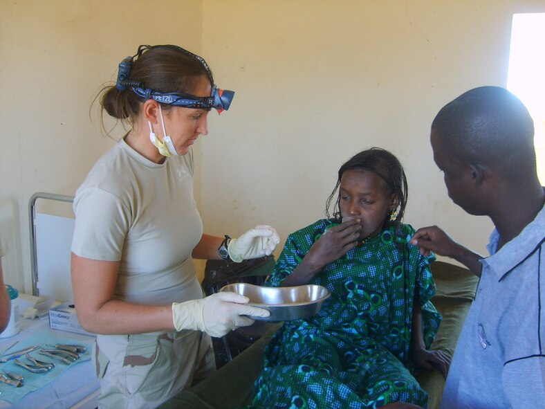 Capt. Sarah Clark, a dentist with the 435th Medical Group, checks the teeth of a Malian child during a Medical Capability program conducted near Gao, Mali. Capt. Clark and other military medical and dental professionals deployed with Special Operations Forces as part of the latest in a series of Joint Combined Exchange Training events. The training, aimed at fostering communication and cultural exchanges between the two militaries, is part of the Untied States effort to maintain positive relationships while bringing stability to the region. (U.S. Air Force photo/Capt. Darrick Lee)
