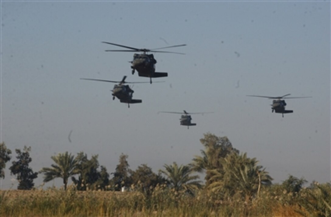 U.S. Army UH-60 Black Hawk helicopters prepare to pick up U.S. Army soldiers from 2nd Battalion, 15th Field Artillery Regiment, 10th Mountain Division, and Iraqi army soldiers from 1st Battalion, 4th Brigade, 6th Iraqi Army Division, in Mahmudiyah, Iraq, Nov. 30, 2006.