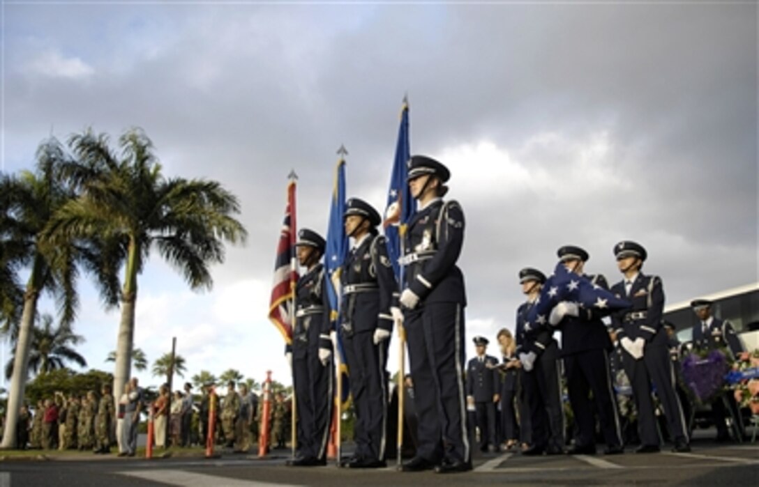 The Hickam Air Force base honor guard commemorates the 65th anniversary of the Pearl Harbor attack, Dec. 7, 1941, on then Hickam Field, Hawaii. A ceremony at the base flagpole was held Dec. 7 to honor the 189 who died and 303 who were wounded during the attack. 