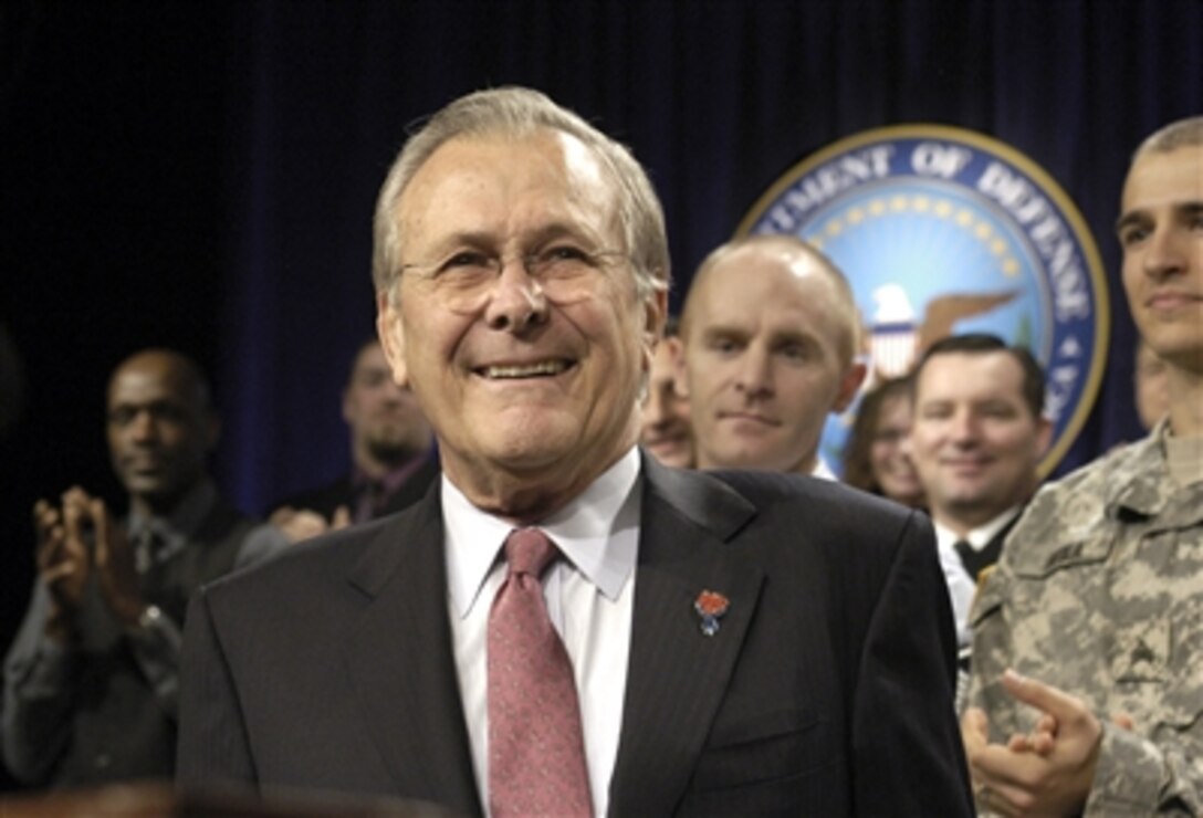 Defense Secretary Donald H. Rumsfeld steps up to the lectern in the Pentagon auditorium for his final town hall meeting with Pentagon employees, Dec. 8, 2006. He was greeted with thunderous applause.                               