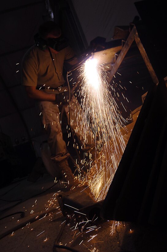 SATHER AIR BASE, Iraq - Staff Sgt. Derek Bowman, a multipurpose vehicle and equipment technician, welds a section of the turret Nov. 28. Members of the 447th Expeditionary Logistics Readiness Squadron Vehicle Maintenance Flight made the turret. (Air Force Photo by Staff Sgt. Scott McNabb)
