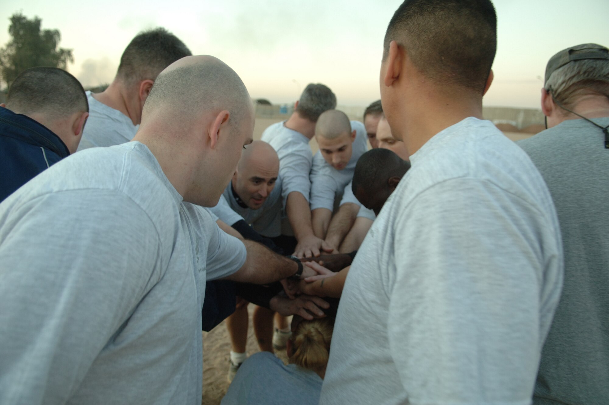 BALAD AIR BASE, Iraq - Air Force Major Caleb Malcolm (center), 332nd Expeditionary Communications Squadron, leads his teammates in a cheer following their victory over the 1744th Transportation Company Company at the Logistics Support Area Anaconda softball field Dec. 2. (U.S. Air Force photo by Airman 1st Class Chad Kellum) 