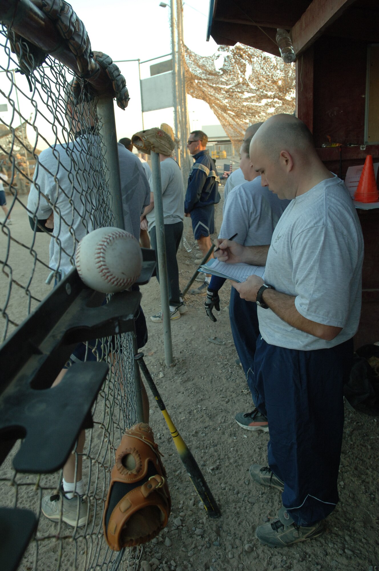 BALAD AIR BASE, Iraq - Air Force Staff Sgt. Terry LaBreck, 332nd Expeditionary Communications Squadron, checks the scorebook in the ECS dugout during a game with the 1744th Transportation Company at the Logistics Support Area Anaconda softball field Saturday. (U.S. Air Force photo by Airman 1st Class Chad Kellum) 