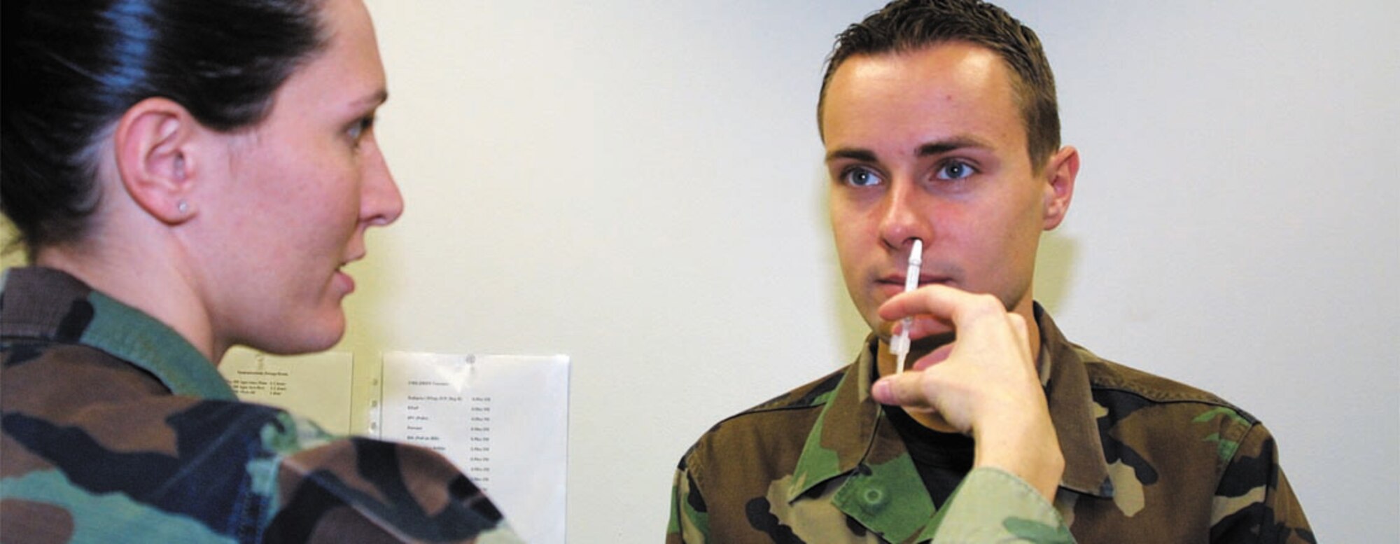 Staff Sgt. Bethany Ladue, 43rd Medical Operations Squadron, gives Senior Airman Andris Kosols, 43rd Civil Engineer Squadron, the FluMist vaccination. All active duty Airmen need to make sure they have been vaccinated.
