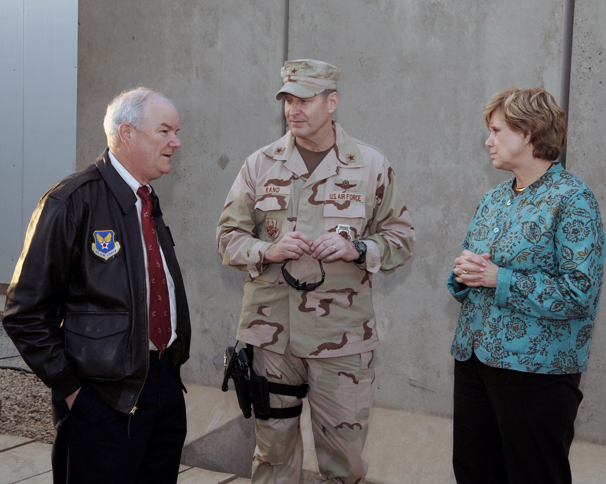 BALAD AIR BASE, Iraq - Secretary of the Air Force Michael Wynne and his wife Barbara, talk with Brig. Gen. Robin Rand, 332nd Air Expeditionary Wing commander. Secretary Wynne and his wife visited Balad, Air Base, Iraq Dec. 9. (U.S. Air Force photo by Tech. Sgt. Paul Cox) 