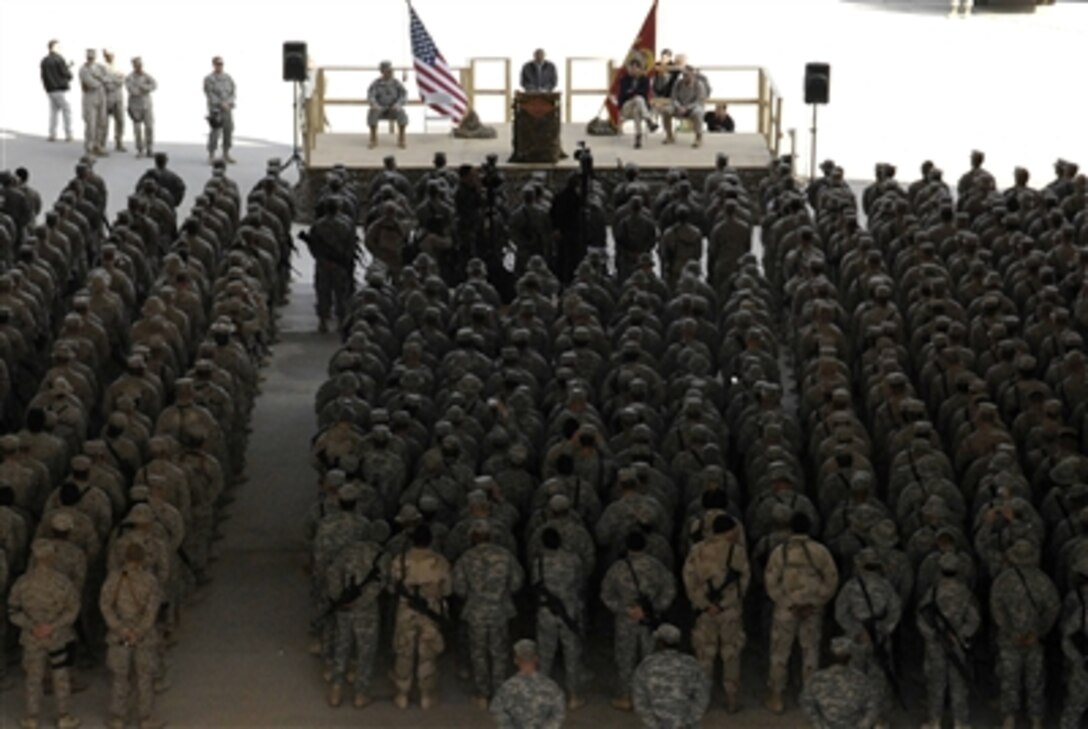 Defense Secretary Donald H. Rumsfeld addresses servicemembers at a Town Hall meeting with troops assigned to Al Asad Air Base during a surprise visit to Iraq, Dec. 9, 2006.