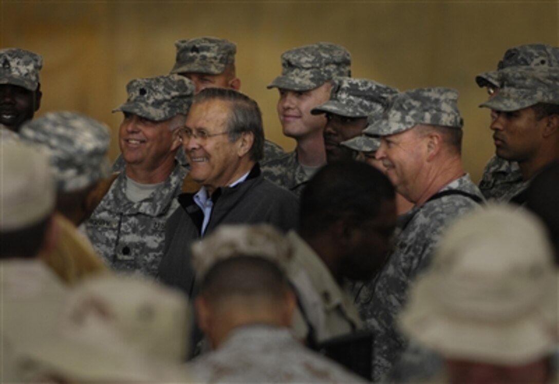 Defense Secretary Donald H. Rumsfeld meets with troops assigned to Al Asad Air Base during a surprise visit to Iraq, Dec. 9, 2006. 