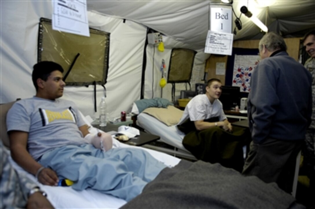 Defense Secretary Donald H. Rumsfeld meets with wounded servicemembers at Balad Air Base during a surprise visit to Iraq, Dec. 9, 2006.