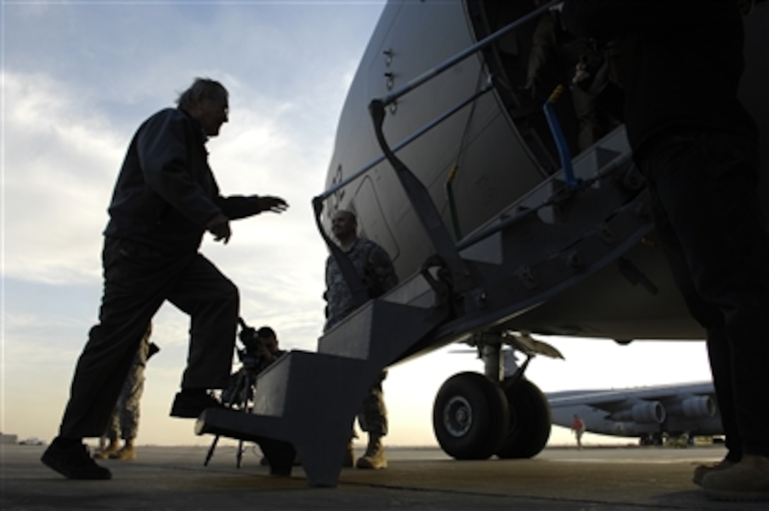 Defense Secretary Donald H. Rumsfeld boards a C-17 after visiting with troops at Balad Air Base, Iraq, during a surprise visit there, Dec. 9, 2006.