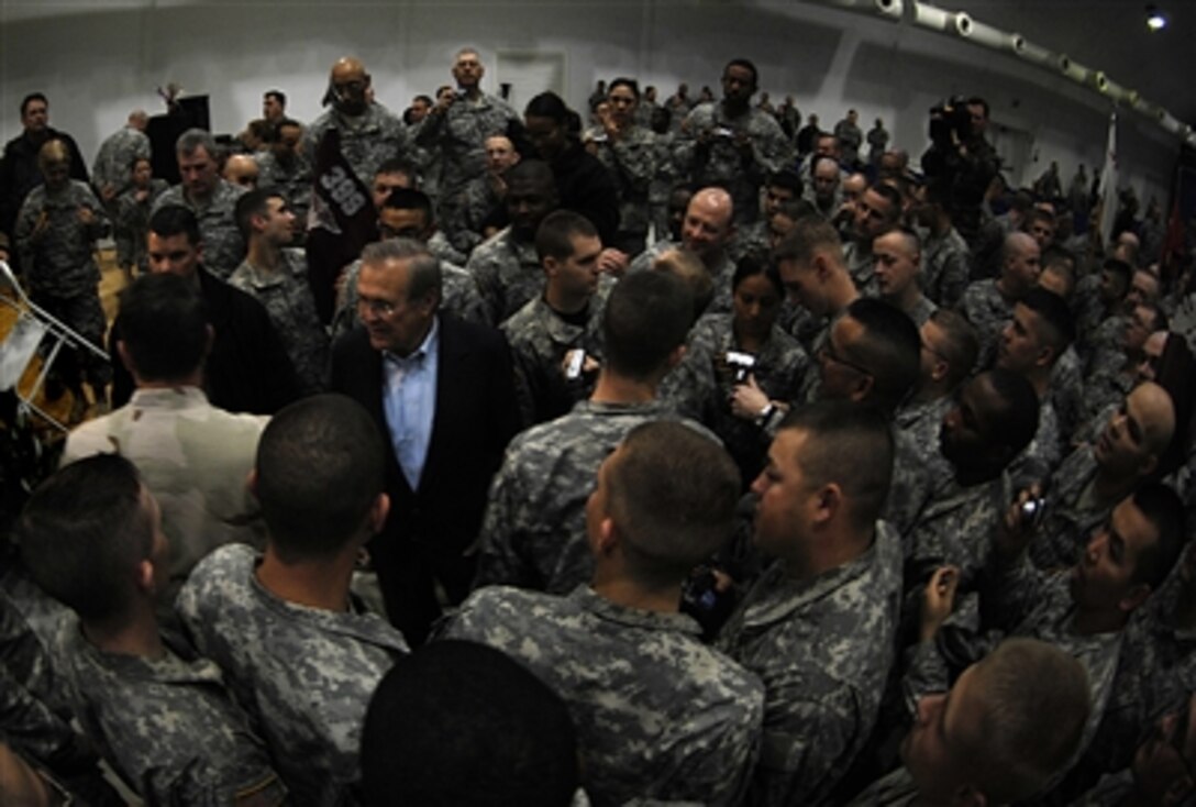 Defense Secretary Donald H. Rumsfeld meets with troops assigned to 4th Brigade of 1st Cavalry Division and 2nd Battalion of 7th Cavalry Regiment, Iraq, during a surprise visit to Iraq, Dec. 9, 2006. Rumsfeld thanked the troops and their families for their sacrifice. 