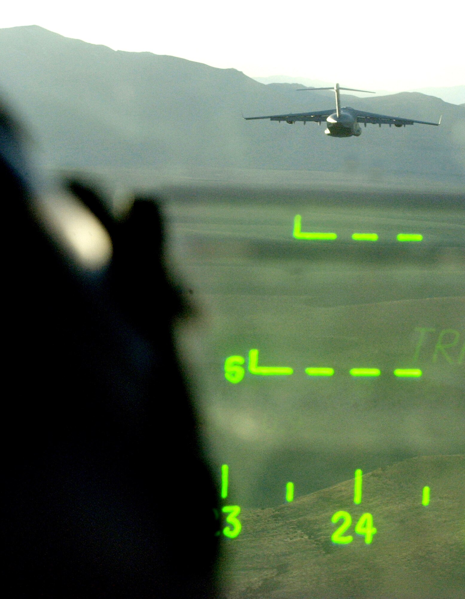 A pilot's view as a C-17 Globemaster III heads out to the Nevada Test and Training range Dec.8 during the U.S. Air Force Weapon School's Mission Employment Phase held at Nellis Air Force Base, Nev. The ME Phase is the final stage of a five-and a- half month course, which trains students in their specialties, and it is the final event prior to Weapons School graduation. (U.S. Air Force photo/ Master. Sgt. Kevin J. Gruenwald)           

