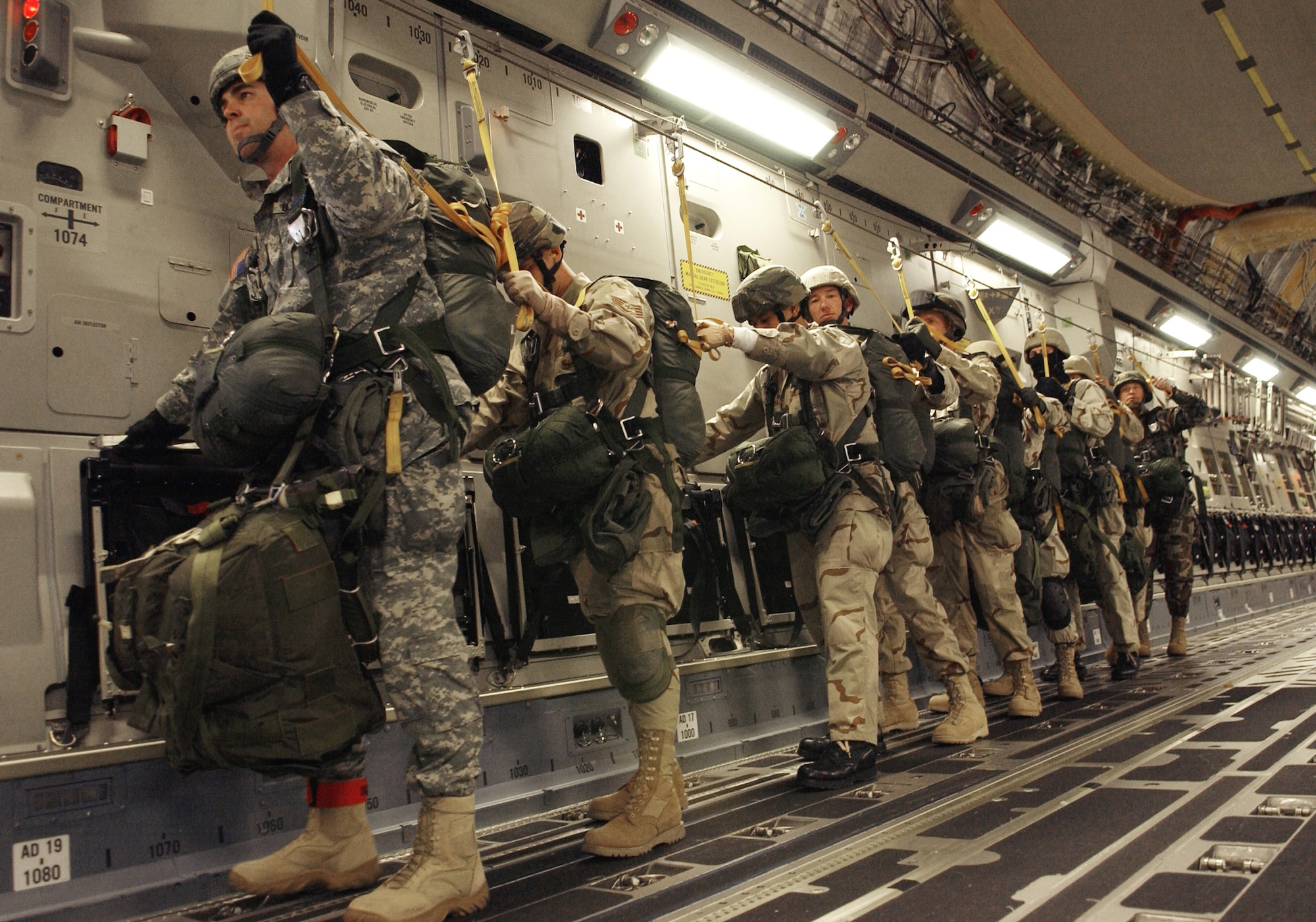 Nellis Air Force Base 820th Civil Engineering Red Horse personnel and Army Airborne members prepare to exit a C-17 Globemaster III Dec.8, during a Mission Employment Exercise held at Nellis. Nearly 80 aircraft from both the Air Force and Navy will participate in the nearly two-week event. ME Phase is the final stage of a five-and a- half month course, which trains students in their specialties. Mission Employment is the final event prior to Weapons School graduation. (U.S. Air Force photo/Master. Sgt. Kevin J. Gruenwald)
            



