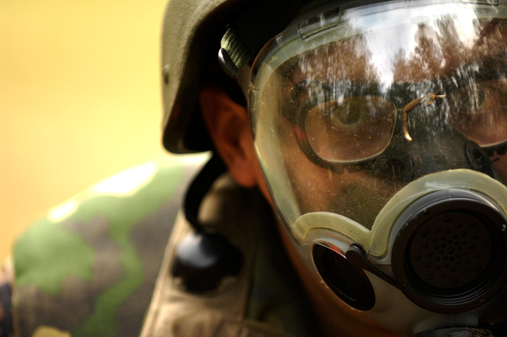 Airman 1st Class Lee Olson dons a gas mask during a simulated gas attack while participating in the Expeditionary Combat Skills Training Dec. 7. at Charleston Air Force Base, S.C. The ECST is a three-day tactical operations course to prepare Charleston Airmen for future deployments. Airman Olson is with the 437th Medical Group. (U.S. Air Force photo/Senior Airman Desiree N. Palacios)