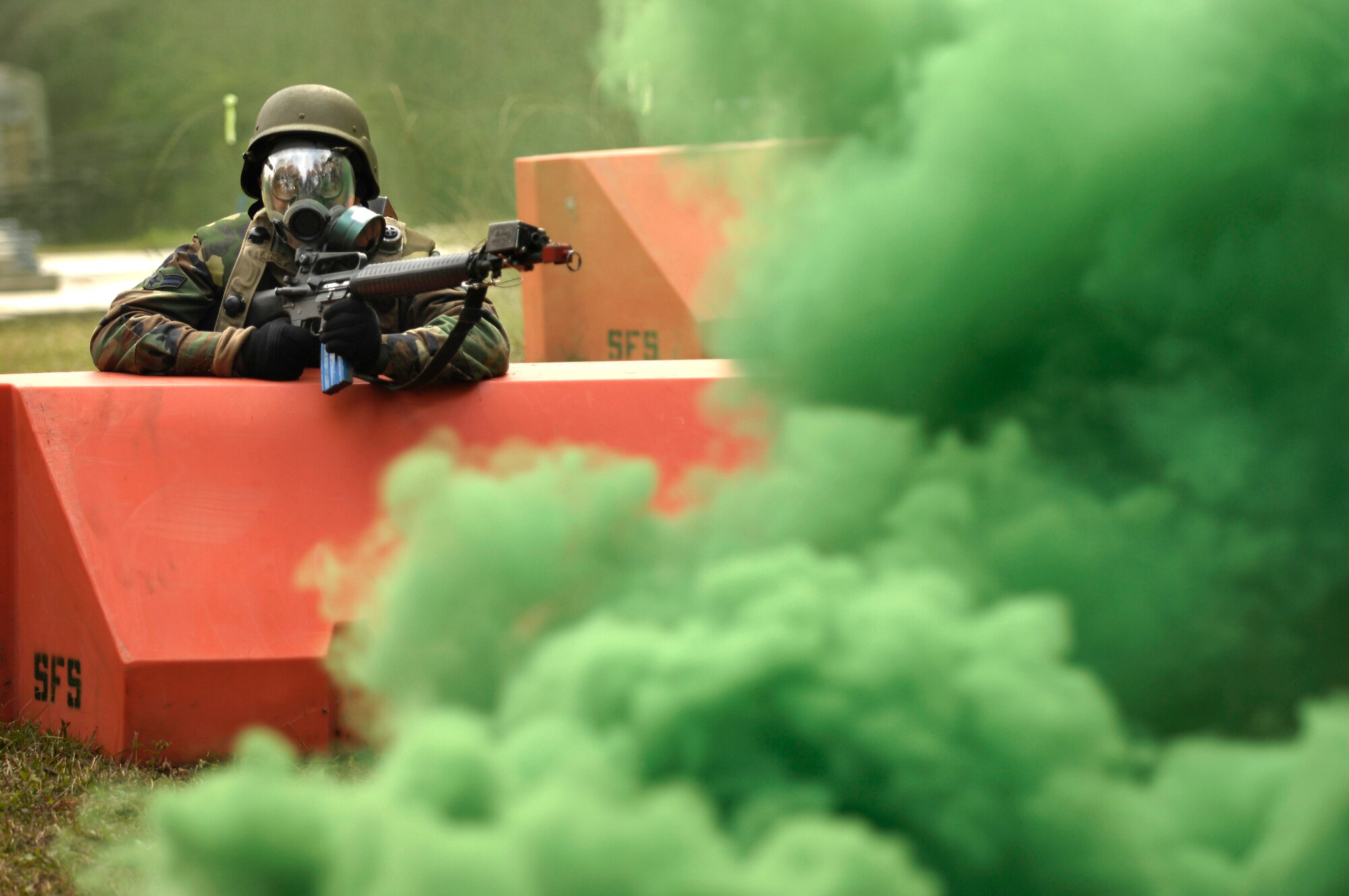 Airman 1st Class Lee Olson dons a gas mask during a simulated gas attack while participating in the Expeditionary Combat Skills Training Dec. 7 at Charleston Air Force Base, S.C. The ECST is a three-day tactical operations course to prepare Charleston Airmen for future deployments. Airman Olson is with the 437th Medical Group. (U.S. Air Force photo/Senior Airman Desiree N. Palacios)