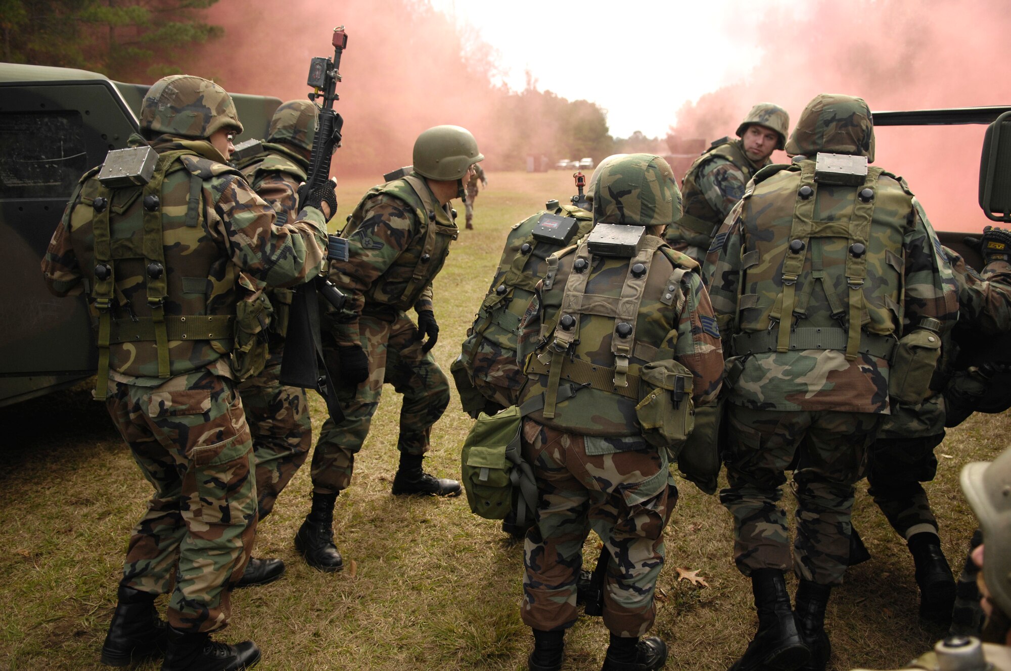 Members of the 437th Airlift Wing cross load through smoke after a vehicle in their convoy was struck by a simulated improvised explosive device during the Expeditionary Combat Skills Training Dec. 7 at Charleston Air Force Base, S.C. The ECST is a three-day tactical operations course to prepare Charleston Airmen for future deployments. (U.S. Air Force photo/Senior Airman Desiree N. Palacios)