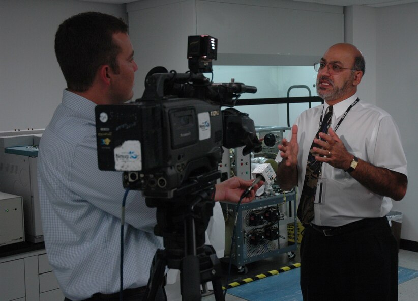 TYNDALL AIR FORCE BASE, Fla. --  Robbie Thomas, a WMBB-TV News reporter, interviews Reza Salavani, energy research group project manager, about the hydrogen fuel cell reformer. (U.S. Air Force photo by 1st Lt. Amanda Ferrell)