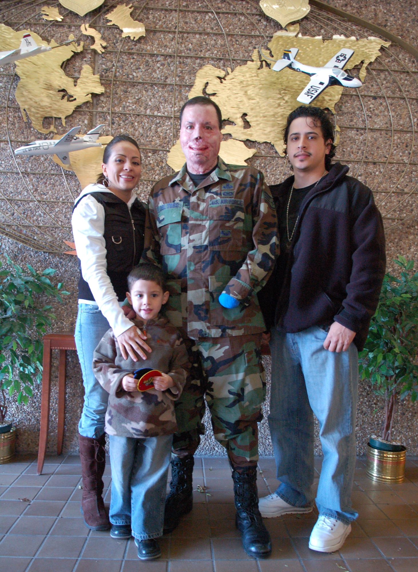 Staff Sgt. Israel Del Toro, supported by his wife Carmen, son Israel and brother Angel Del Toro, continues to recover after being severely injured by an improvised explosive device during a mission in Afghanistan.  Sergeant Del Toro is a tactical air control party Airman.  (U.S. Air Force photo)