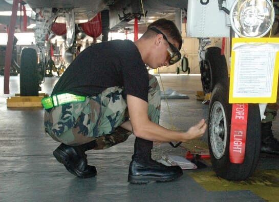 TYNDALL AIR FORCE BASE, Fla. --  Airman 1st Class Scott Ledien, 372nd Training Squadron/Detachment 4 mission ready airman, checks the pressure on the front tire of an F-15. He and three other students graduate today. After training to become an Eagle crew chief, he will be stationed at Langley AFB, Va. (U.S. Air Force photo by Chrissy Cuttita)