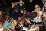 Children gather around to help Brig. Gen. Darrell Jones, then the 37th Training Wing commander, throw the switch that powers the Christmas Tree lights. 