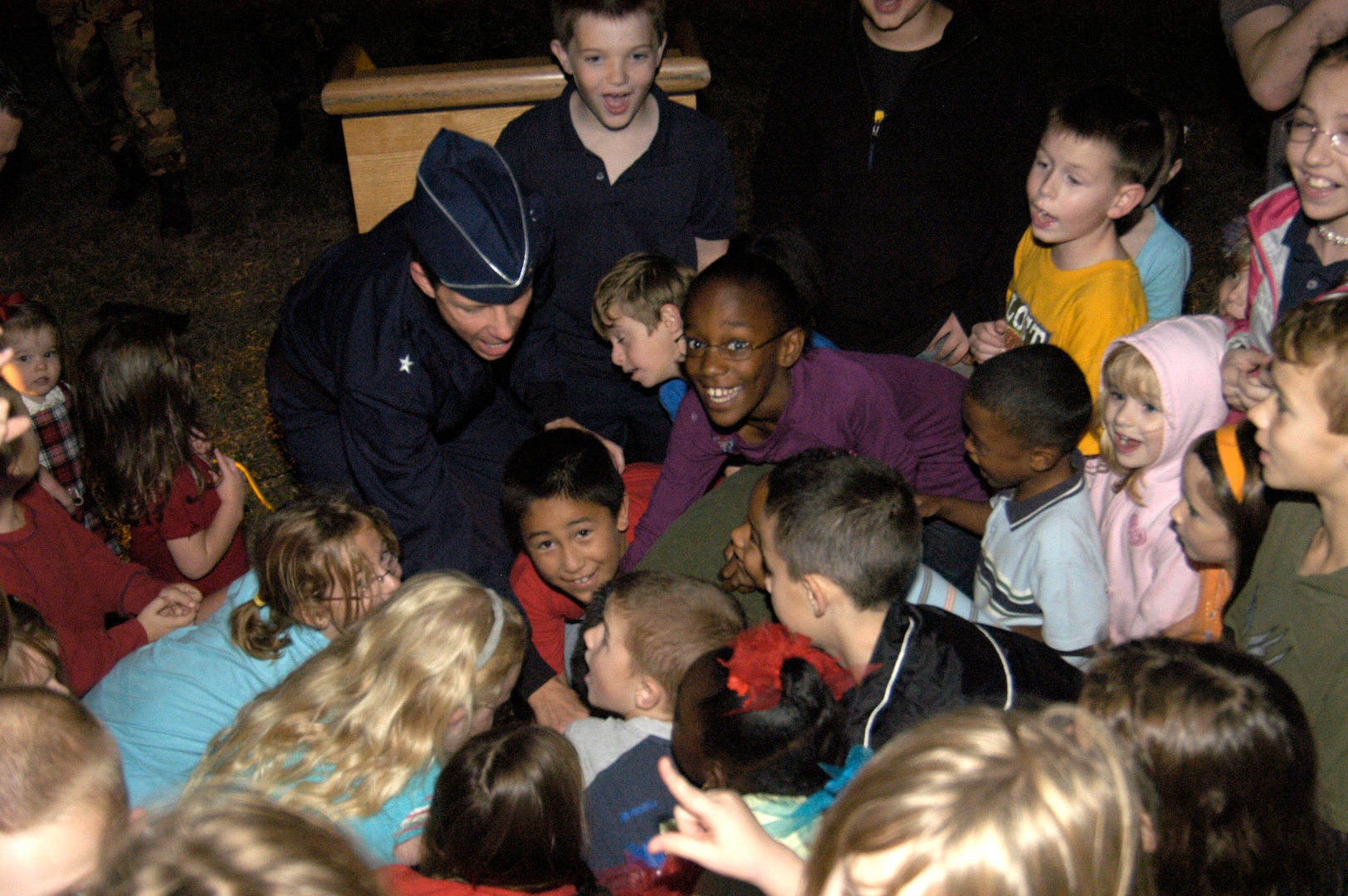 Children gather around to help Brig. Gen. Darrell Jones, then the 37th Training Wing commander, throw the switch that powers the Christmas Tree lights. 