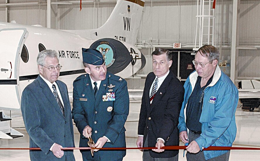 (Photo by Terry Wasson) Irv Honigsberg, Enid mayor; Col Mike Callan, 71st Flying Training Wing commander; Walt Garner, Army Corp of Engineer district director; and John Cole, DynCorp program manager, cut the ribbon, opening the new T-1 hangar Monday.