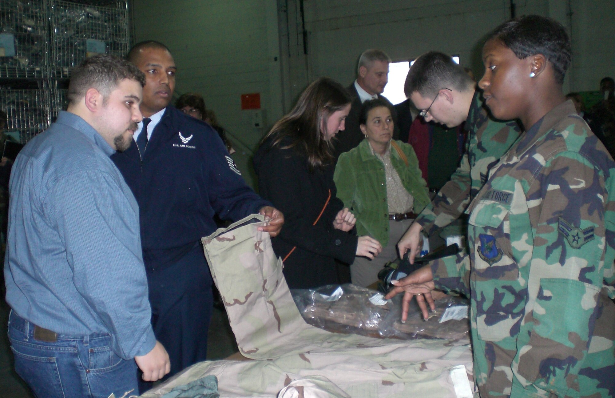 MCGUIRE AIR FORCE BASE, N.J. -- Readiness Airmen from the 305th Logistics Readsiness Squadron speak to tour attendees about the Airman desert battle dress uniform. U.S. Air Force Photo by Senior Airman Dilia DeGrego
