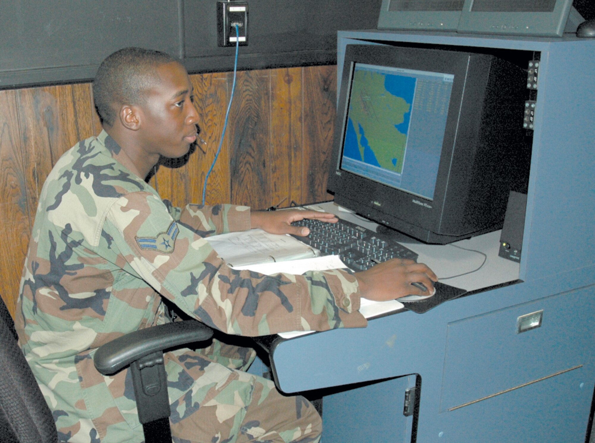 TYNDALL AIR FORCE BASE, Fla. --  Airman 1st Class Darryl Robinson, 325th Operations Support Squadron air traffic control specialist, runs a scenario for airfield operations officers training here. At the computer, he works as a supervisor and stages the environment. These specialists guide students through air traffic control situations that they may observe on the flightline. (U.S. Air Force photo by Chrissy Cuttita)