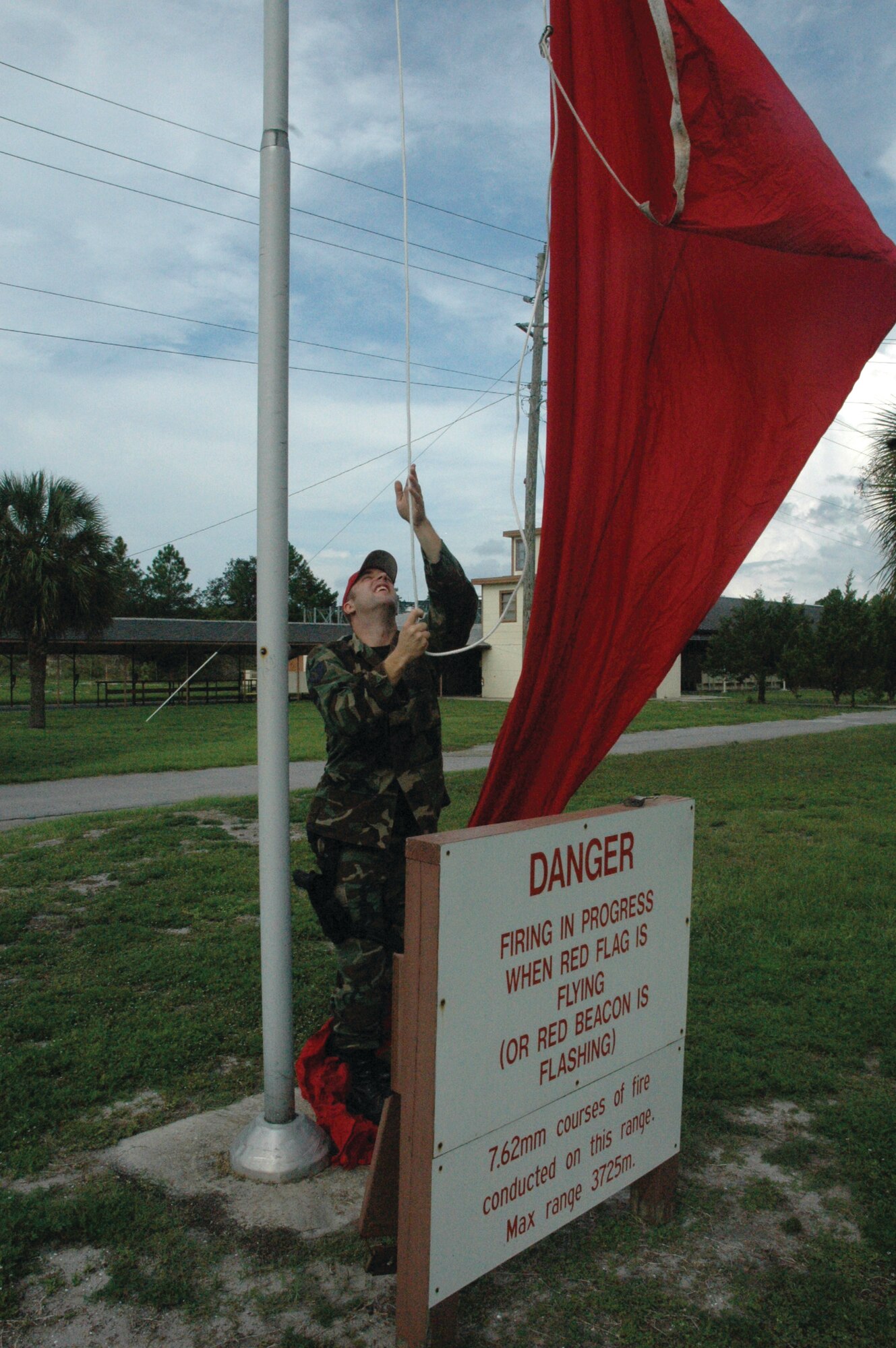 TYNDALL AIR FORCE BASE, Fla. --  Staff Sgt. Brasndon Binczak, 325th Security Forces Squadron combat arms instructor, raises the red flag in front of the range before M-9 training Monday morning. The red flag serves as a reminder to personnel driving or walking by that live fire is on the range. No one is allowed to go behind the range at this time. (U.S. Air Force photo by Chrissy Cuttita)