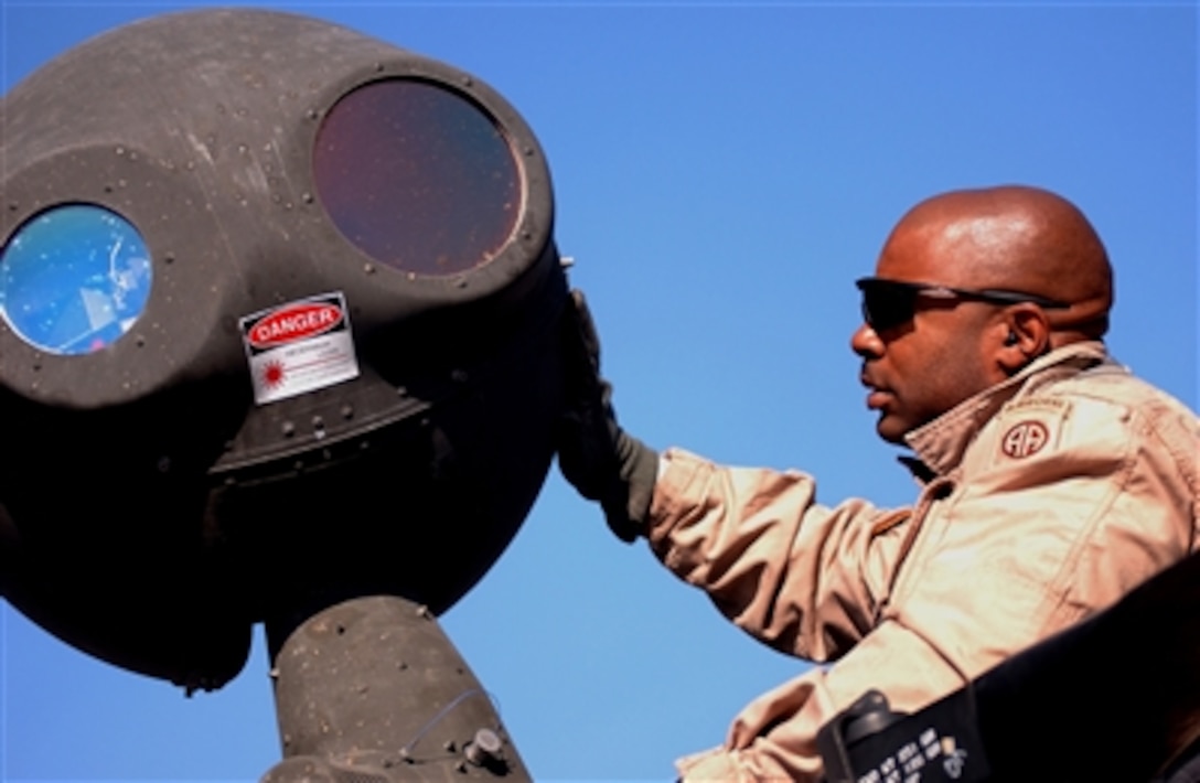 Army Chief Warrant Officer Mike Zanders conducts a preflight inspection on the thermal imaging sensor of an OH-58D Kiowa Warrior helicopter at Forward Operating Base Sykes, Iraq, on Dec. 3, 2006.  The Kiowa is a scout attack aircraft used for close air support and surveillance.  Zanders is attached to the 1st Squadron, 17th Cavalry Regiment.  