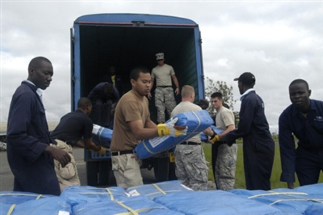 U.S. Navy sailors and soldiers help Kenyan workers as they unload plastic shelters for victims of severe flooding in the Dadaab, Kenya, on Dec. 10, 2006. U.S. aircrews, assigned to Combined Joint Task Force - Horn of Africa, are air-dropping relief supplies and humanitarian aid for the approximately 160,000 stranded victims of recent flooding in rural areas of Kenya.  