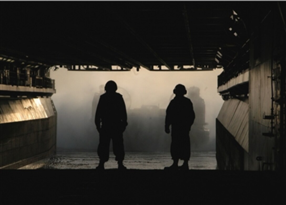 U.S. Navy sailors onboard the USS Wasp guide a landing craft air cushion into the well deck during LCAC operations in the Atlantic Ocean, Nov. 27, 2006.